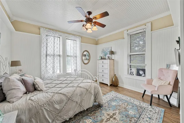 a bedroom with a bed and a large window