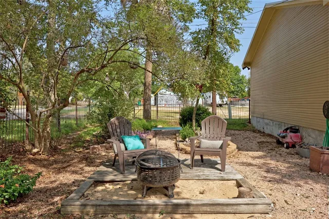 a view of a patio with chairs and potted plants