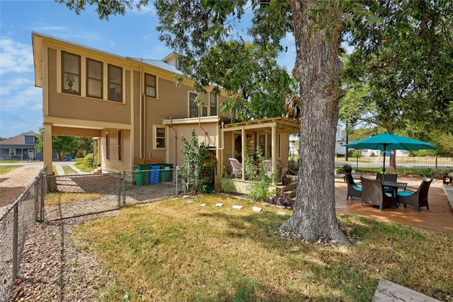a view of a house with a tree in a yard