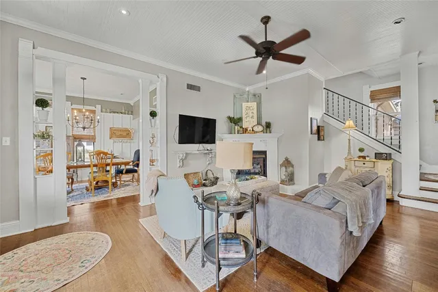 a living room with furniture and a flat screen tv with wooden floor