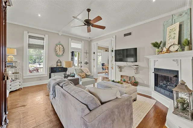 a living room with furniture a fireplace and a flat screen tv