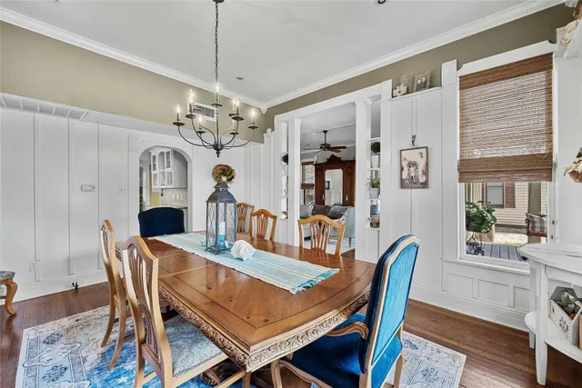 a view of a dining room with furniture a chandelier and wooden floor