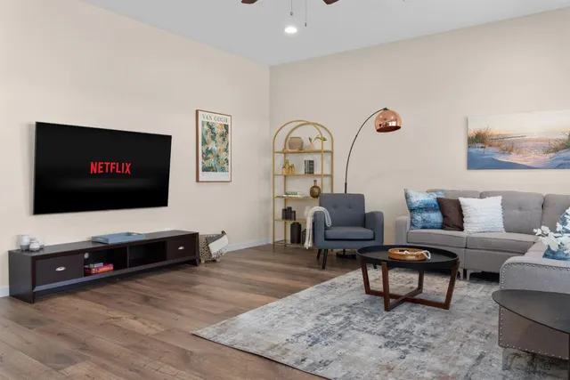 a bedroom with a bed window and a night stand