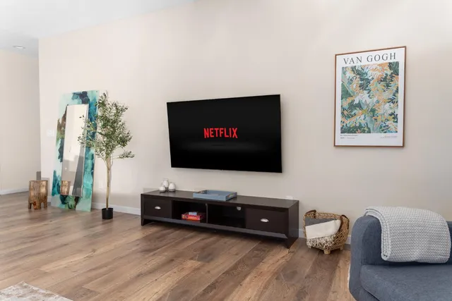 a bedroom with a bed a chair and a window