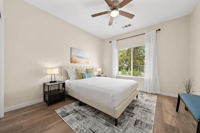 a bedroom with a bed and a potted plant