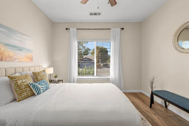 a bedroom with a large bed and a chandelier