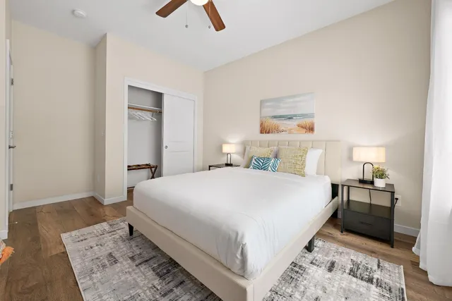 a bedroom with a bed and a potted plant