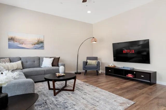 a bathroom with a granite countertop sink a toilet and a mirror
