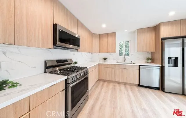 a kitchen with a sink stove and microwave