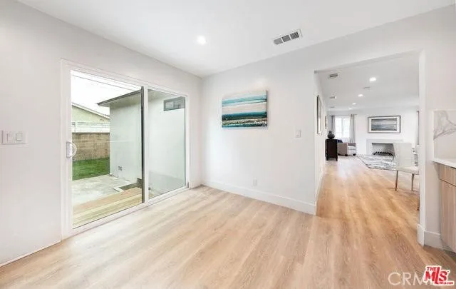 a view of a room with wooden floor and a bathroom