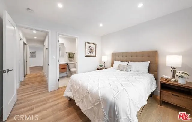 a spacious bedroom with a bed and a view of bathroom