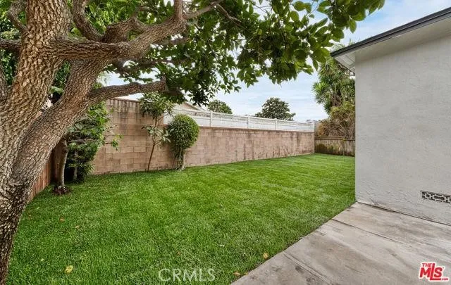 a view of a backyard with large trees