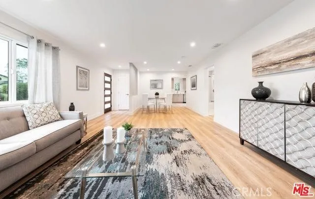 a spacious bedroom with a large bed and a couch