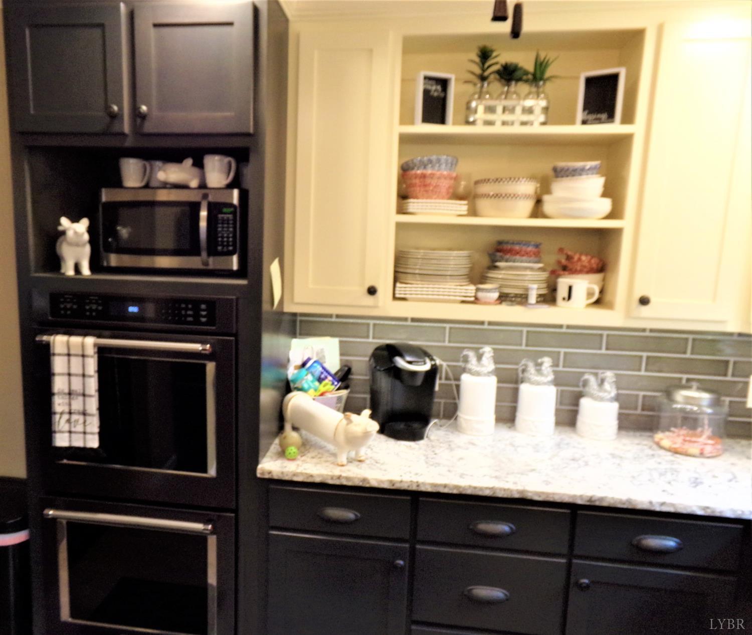 671 Countyline Road Keysville, VA 23947 - Photo 11 of 38 a kitchen with granite countertop lots of clutter and cabinets