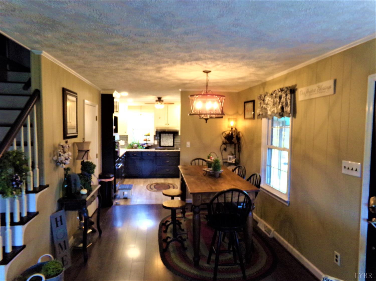 671 Countyline Road Keysville, VA 23947 - Photo 12 of 38 a very nice looking room with many windows and furniture