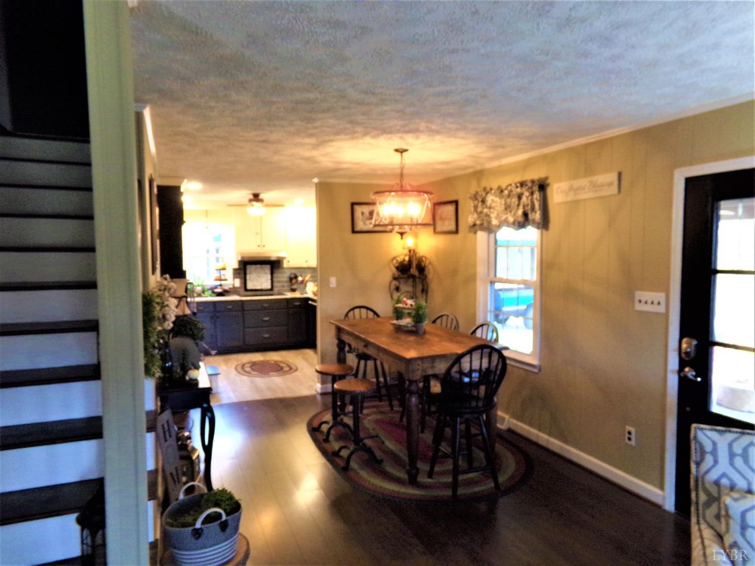 671 Countyline Road Keysville, VA 23947 - Photo 13 of 38 a dining room with furniture and wooden floor