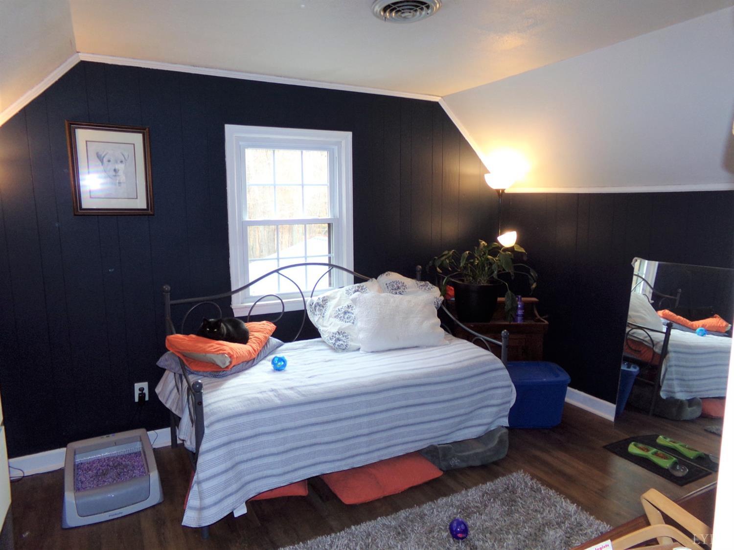 671 Countyline Road Keysville, VA 23947 - Photo 23 of 38 a bedroom with a bed and wooden floor