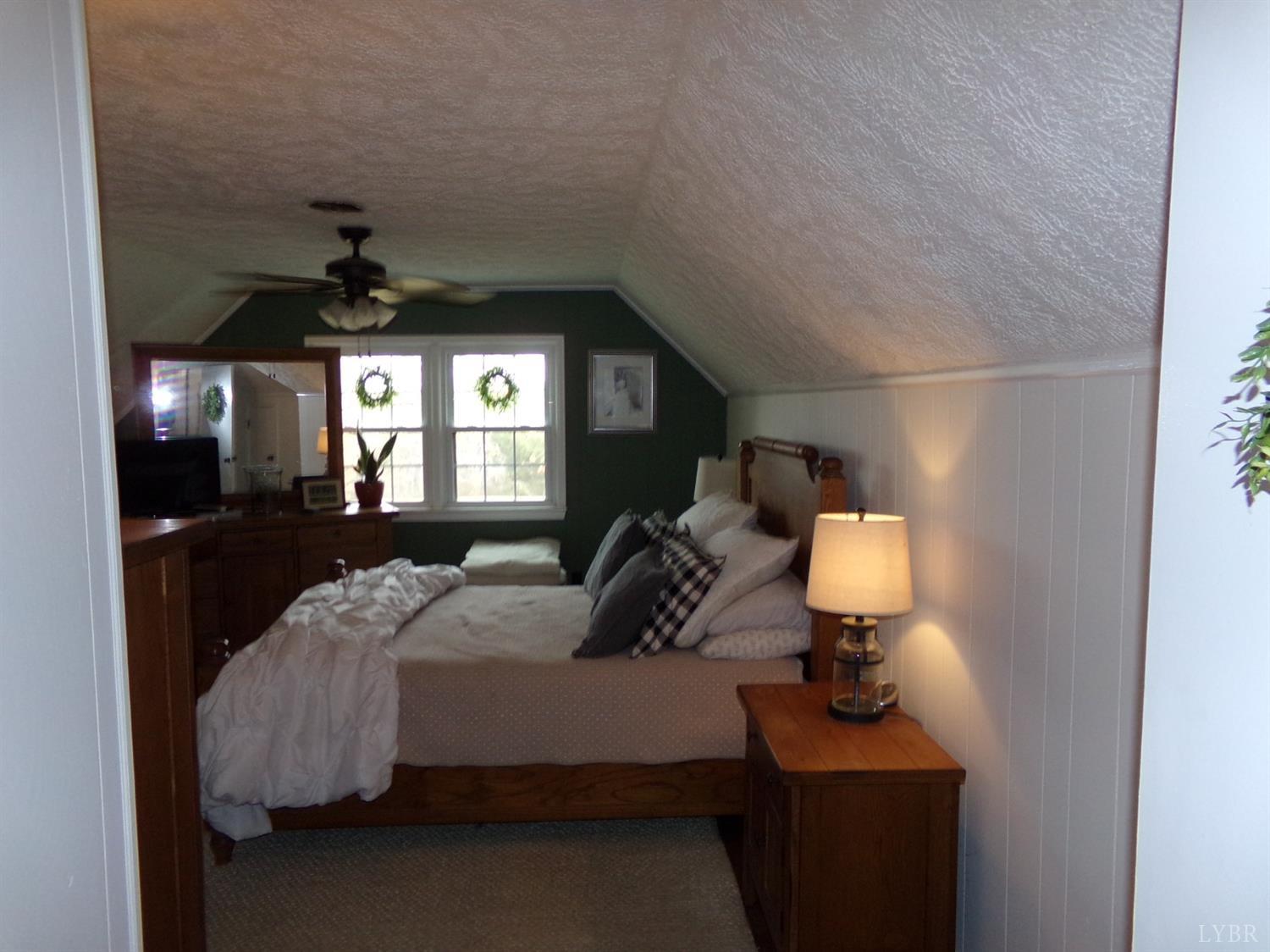 671 Countyline Road Keysville, VA 23947 - Photo 24 of 38 a bedroom with a bed mirror and window