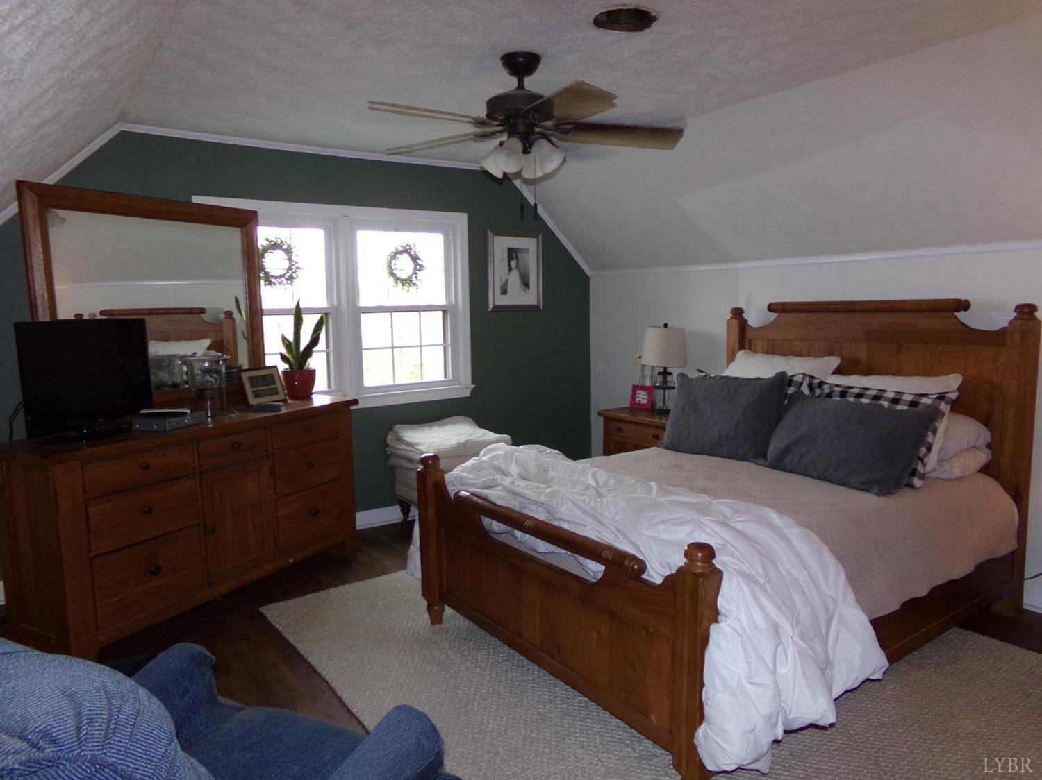 671 Countyline Road Keysville, VA 23947 - Photo 25 of 38 a bedroom with a bed and a dresser