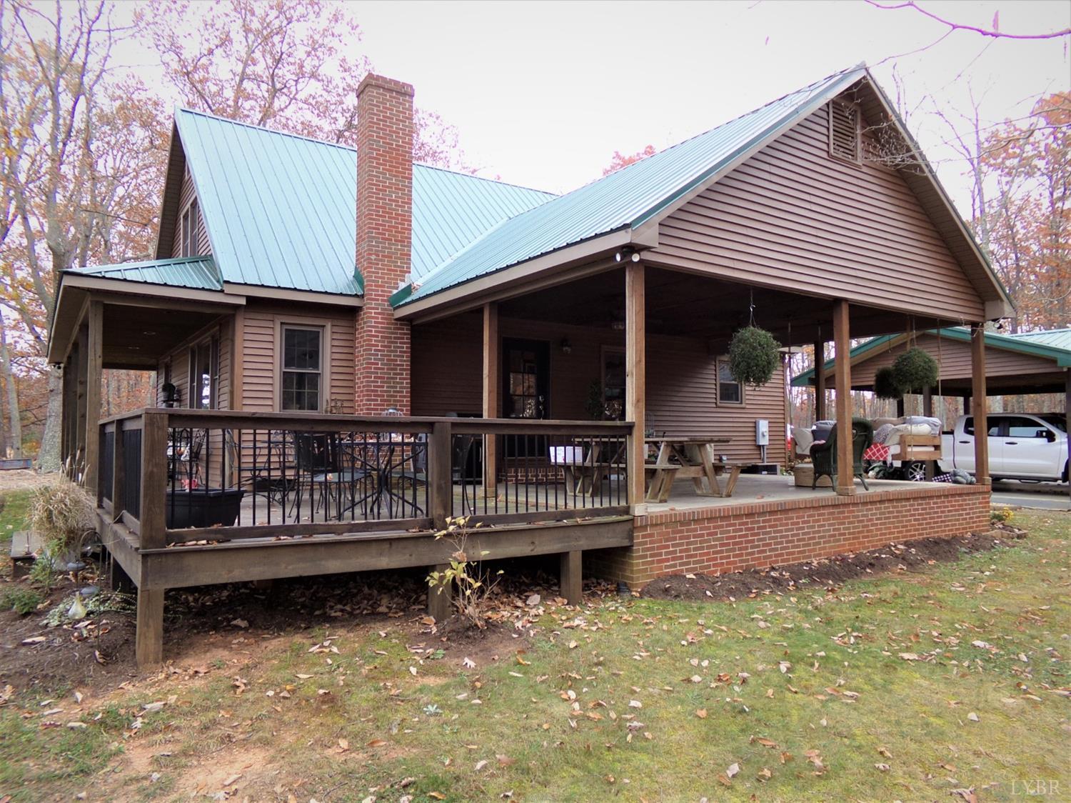 671 Countyline Road Keysville, VA 23947 - Photo 5 of 38 a view of a house with wooden deck and furniture