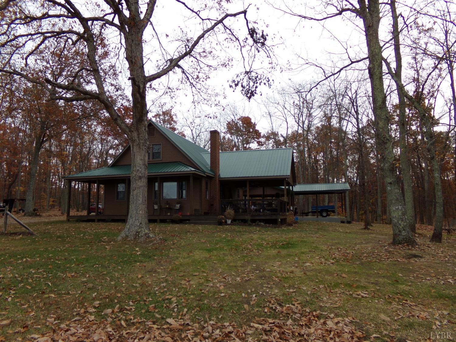671 Countyline Road Keysville, VA 23947 - Photo 6 of 38 a view of a house with a yard and large trees