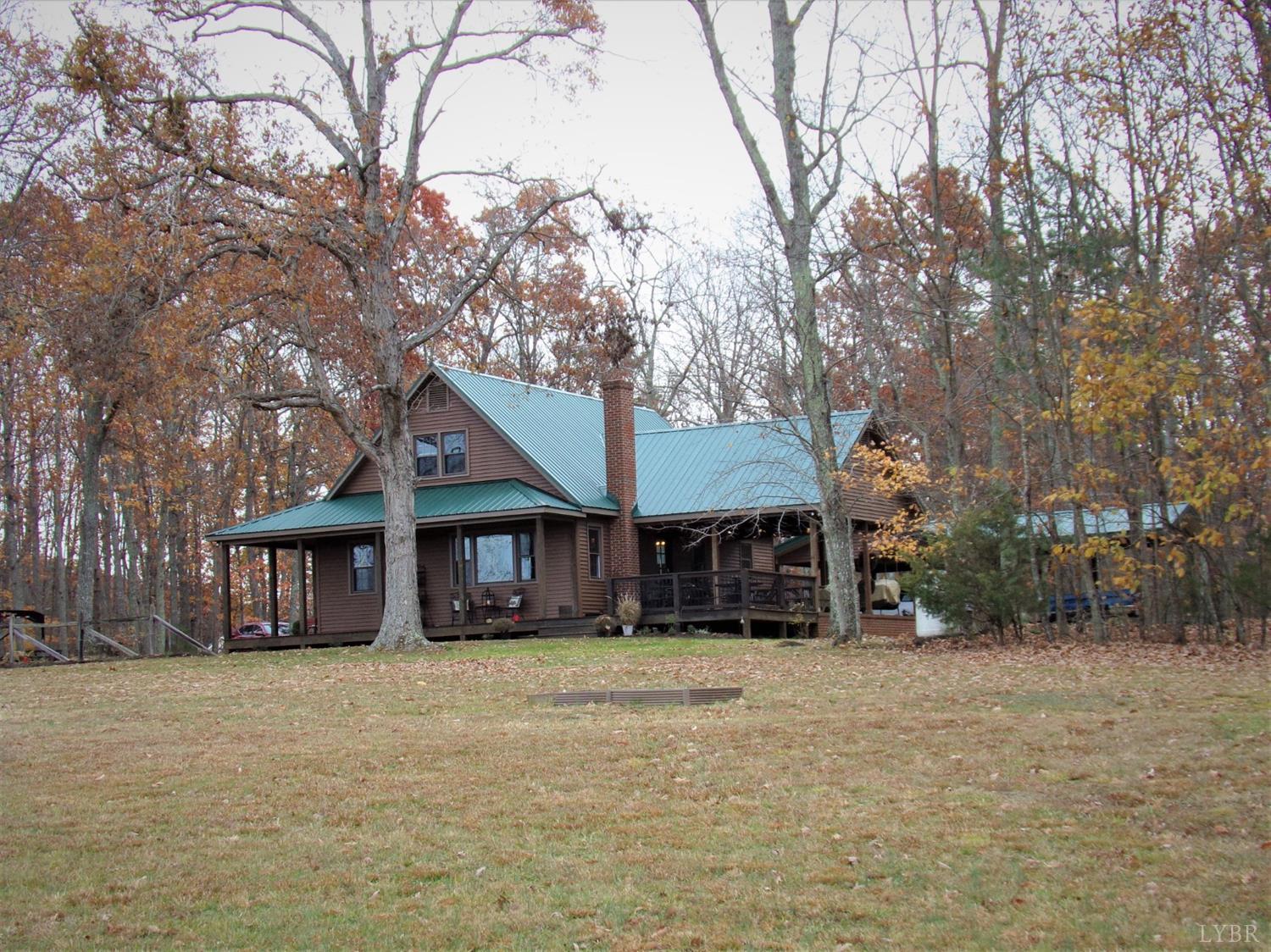 671 Countyline Road Keysville, VA 23947 - Photo 7 of 38 a front view of a house with a yard and large trees