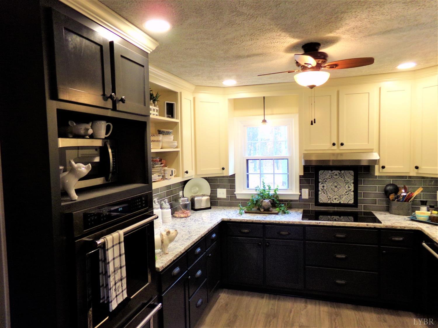 671 Countyline Road Keysville, VA 23947 - Photo 8 of 38 a kitchen with a sink stainless steel appliances and cabinets
