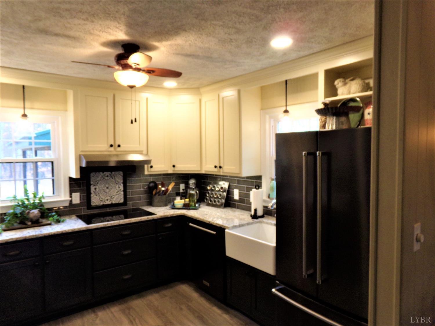 671 Countyline Road Keysville, VA 23947 - Photo 9 of 38 a kitchen with a sink and refrigerator