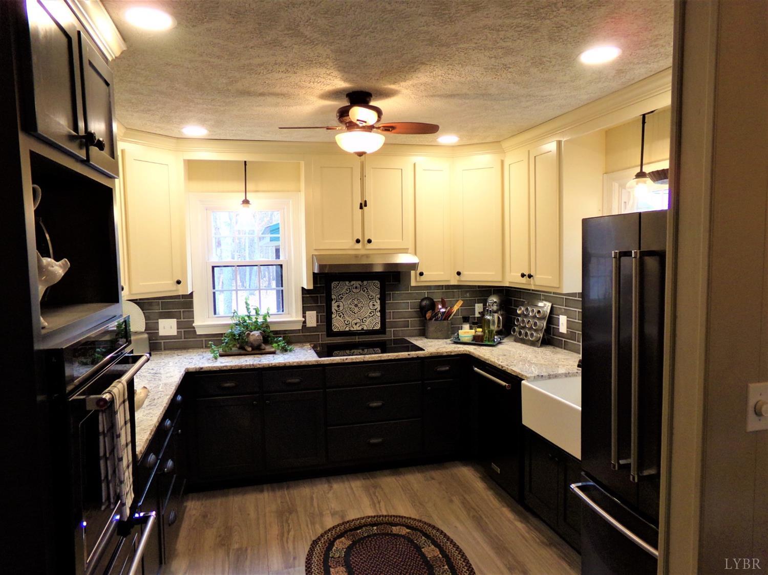 671 Countyline Road Keysville, VA 23947 - Photo 10 of 38 a kitchen with a sink appliances and cabinets