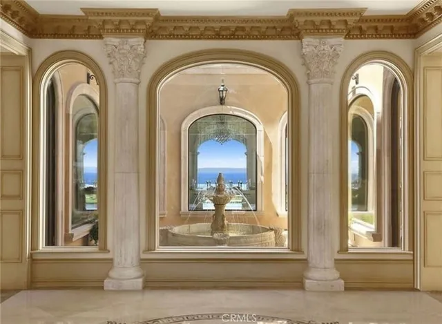 a living room with fireplace furniture and a chandelier
