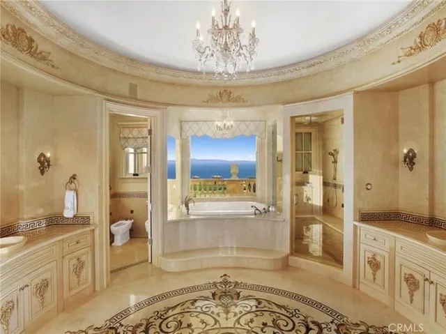 a living room with furniture a fireplace and a chandelier