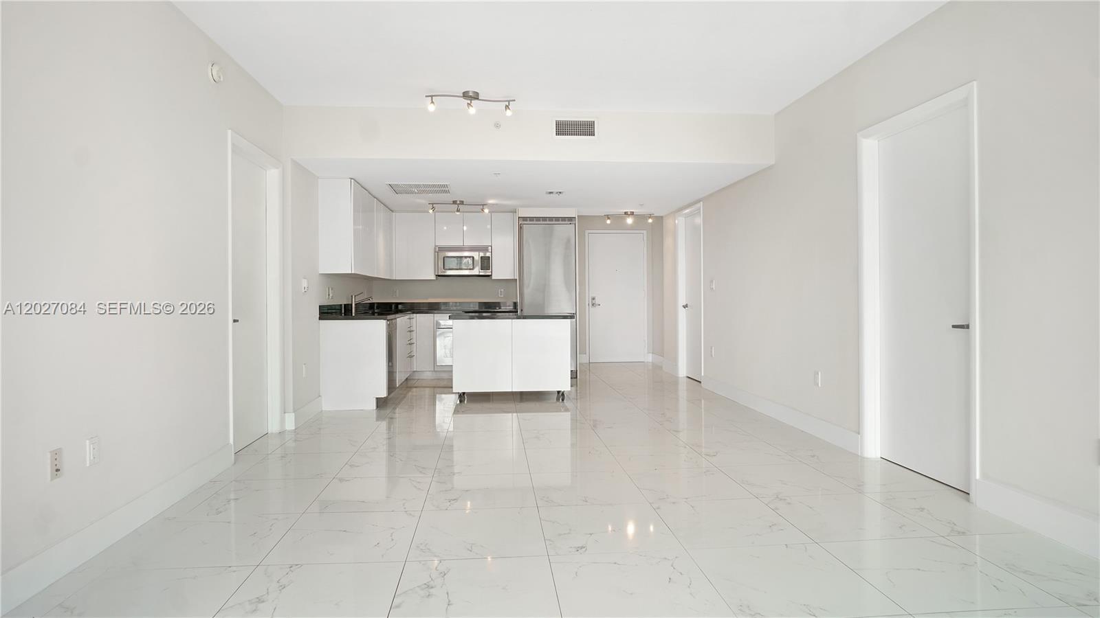 92 Southwest 3rd Street, Unit 1803 Miami, FL 33130 - Photo 5 of 29 a view of a kitchen with a sink cabinets and stainless steel appliances