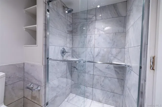 a bathroom with a glass shower door