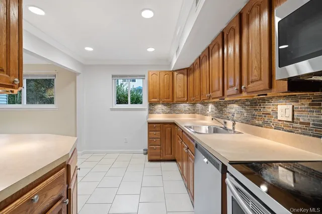a kitchen with a sink stove top oven and cabinets