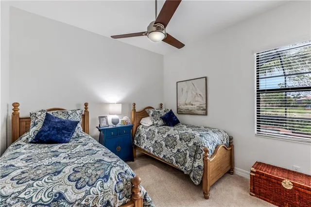 a bedroom with two beds and painting on the wall