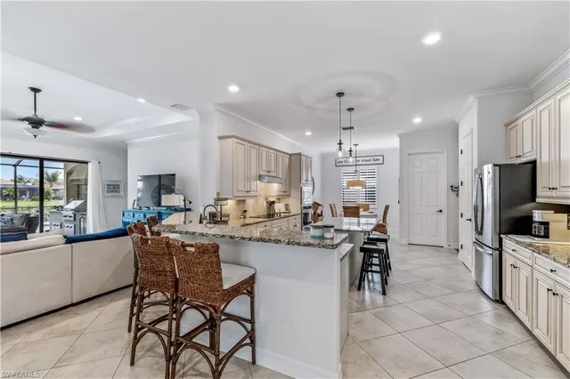 a kitchen with stainless steel appliances kitchen island granite countertop a sink and cabinets