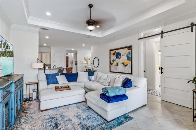 a living room with furniture a rug and a painting