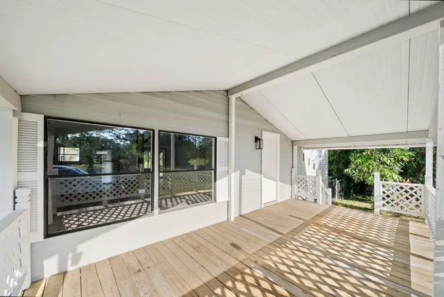 a bedroom with a bed and a large window with outer view