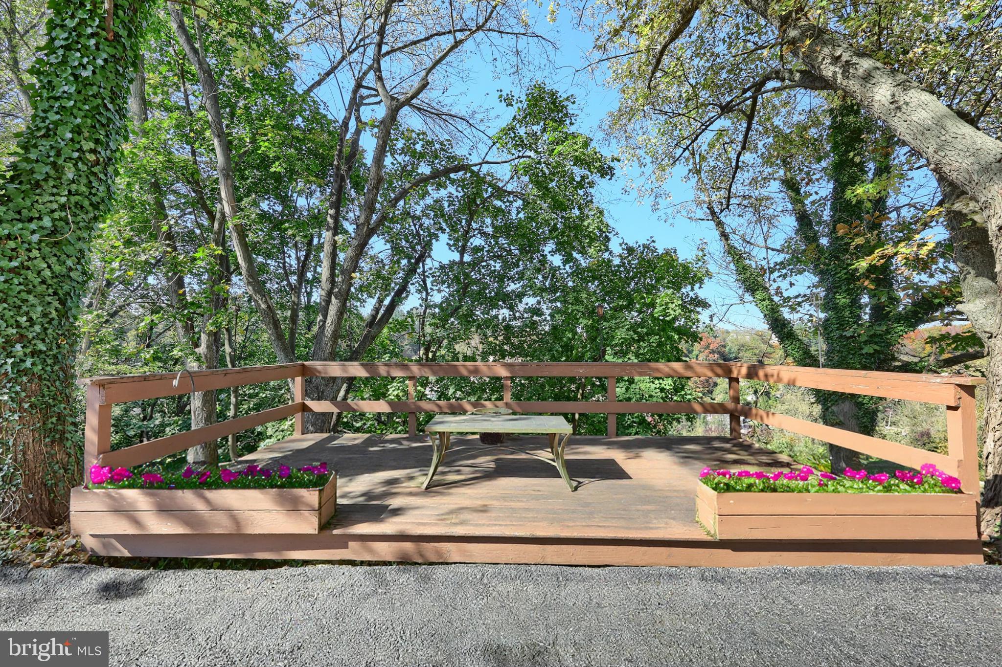 150 Ridge Avenue Glen Rock, PA 17327 - Photo 7 of 49 Serene deck surrounded by lush greenery.