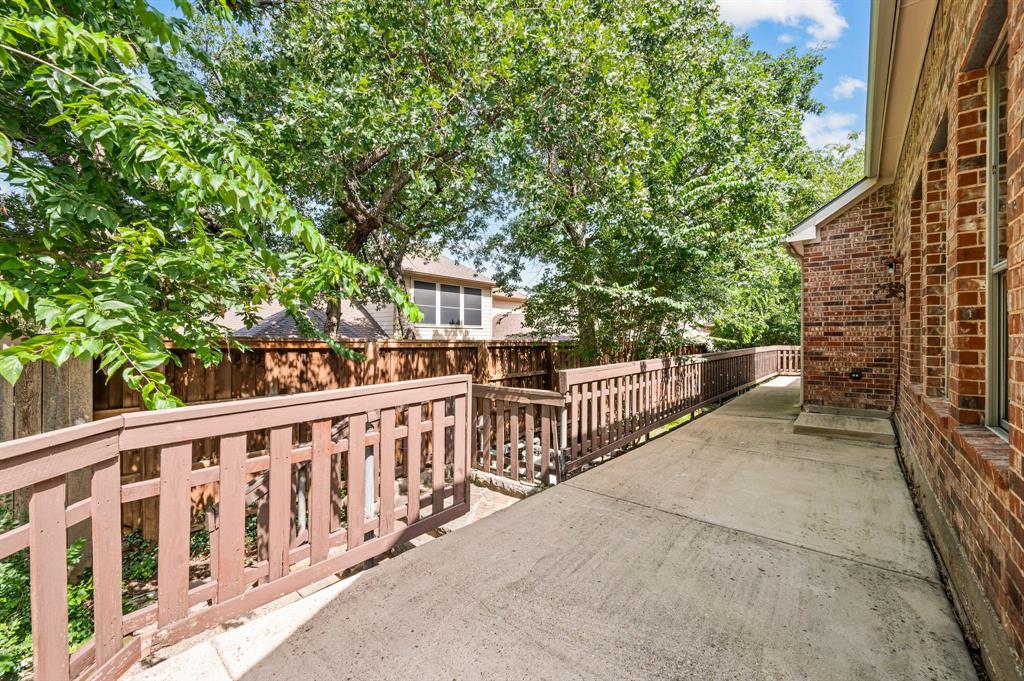 808 Briar Ridge Drive Keller, TX 76248 - Photo 34 of 40 Exterior concrete walkway bordered by a wooden fence with wood railings