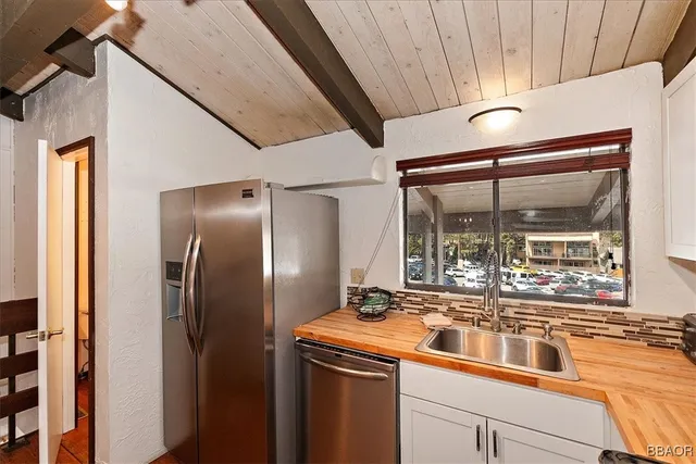 a kitchen with a refrigerator and a sink