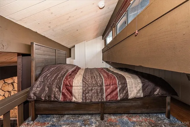 a bed sitting in a bedroom next to a window