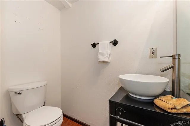 a white toilet sitting next to a bathroom sink