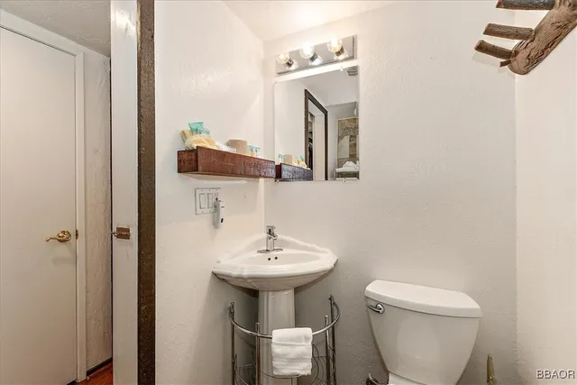 a bathroom with a glass shower door and a mirror