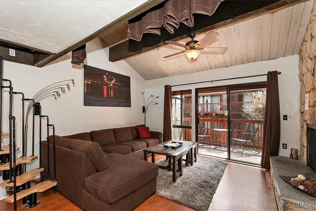 a living room with furniture a flat screen tv and a table