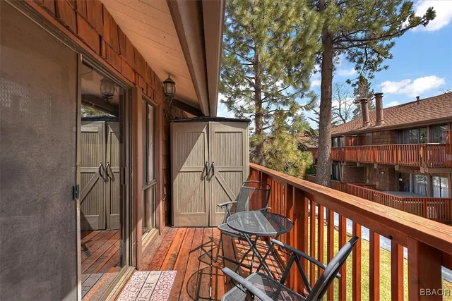 a view of balcony with wooden floor and fence