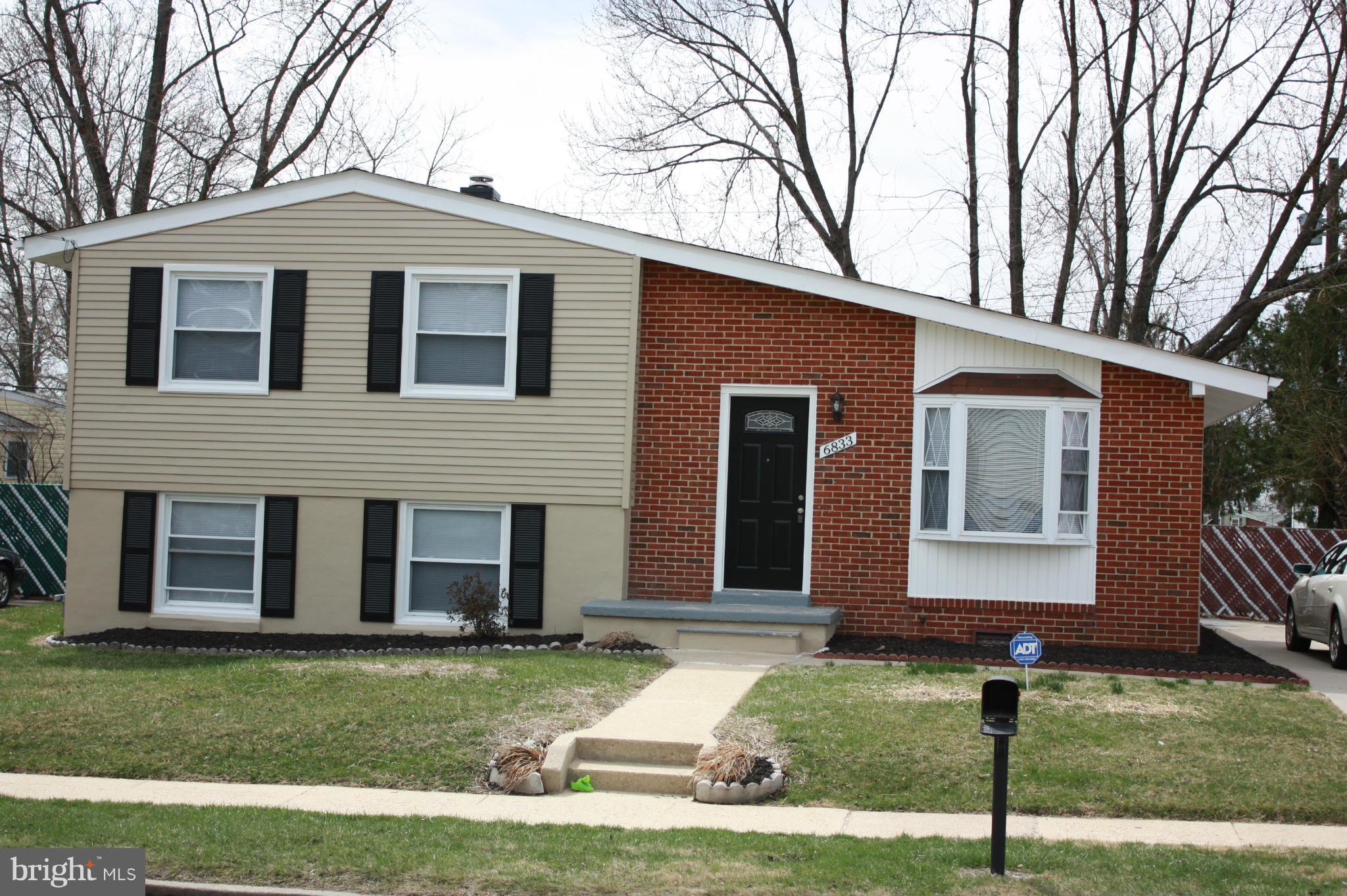 6833 Windsor Mill Road Baltimore, MD 21207 - Photo 1 of 17 a front view of a house with a yard