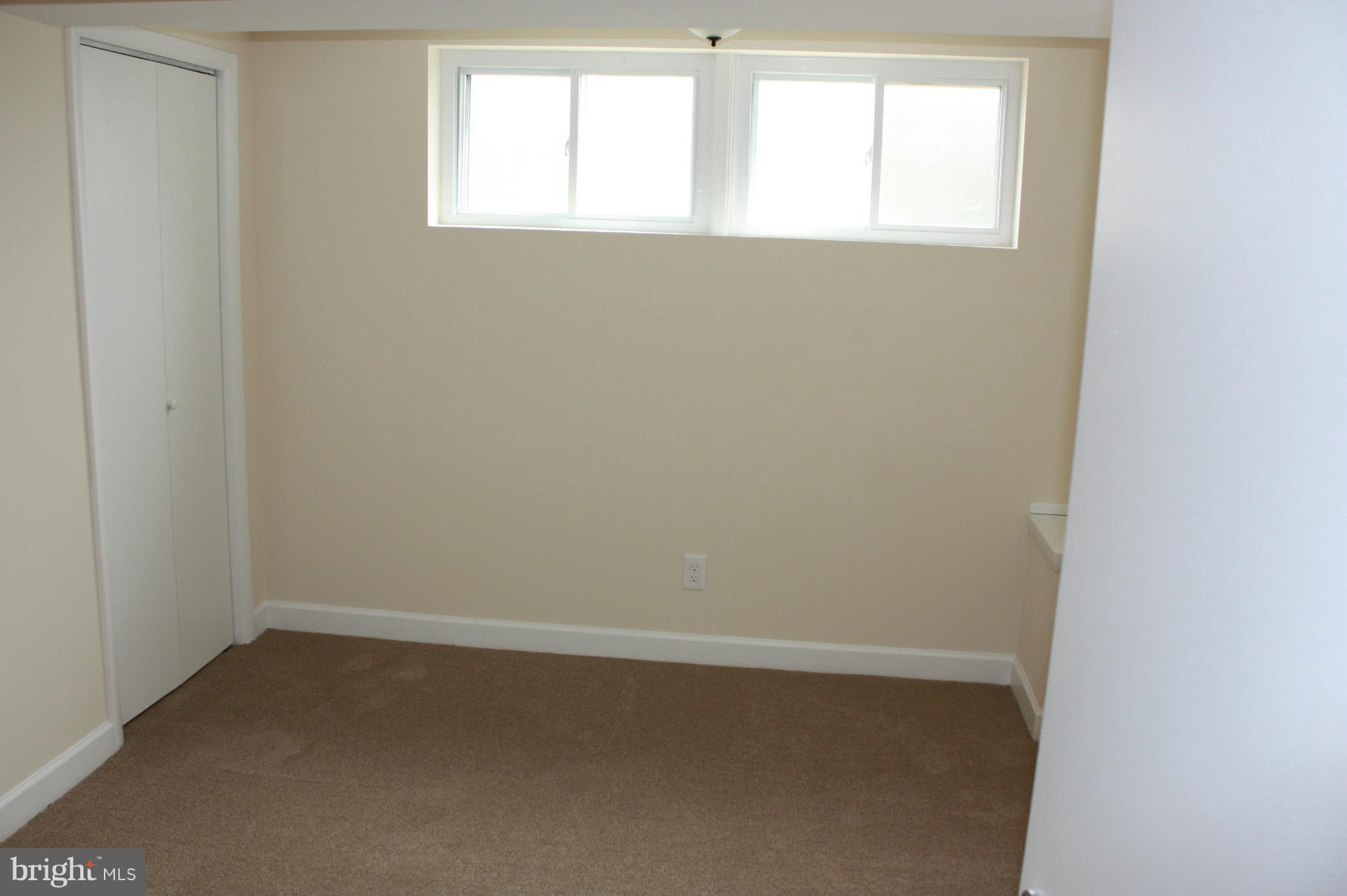 6833 Windsor Mill Road Baltimore, MD 21207 - Photo 15 of 17 an empty room with a window
