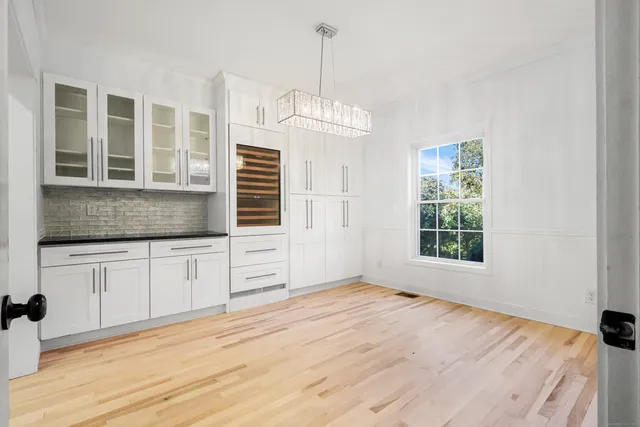 a bedroom with a bed dresser and a window