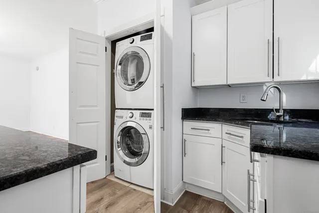 a utility room with sink dryer and washer